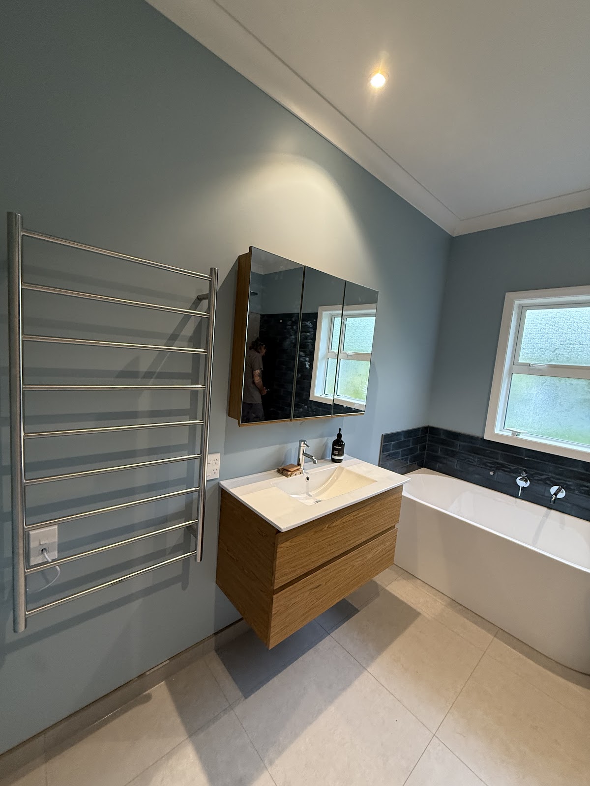 Renovated bathroom with heated towel rail, mirror cabinet and downlights